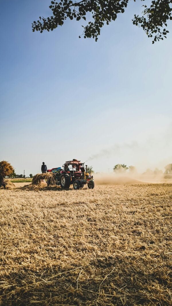 Person Using an Agricultural Machine Tractor on Field